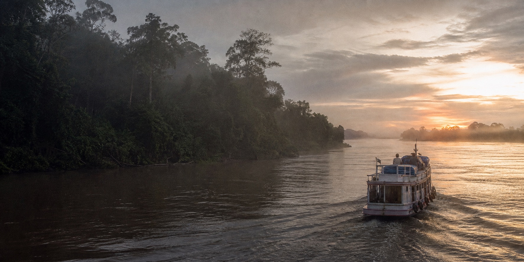 A small working passenger boat moving along a broad forest-lined Amazon river at dawn